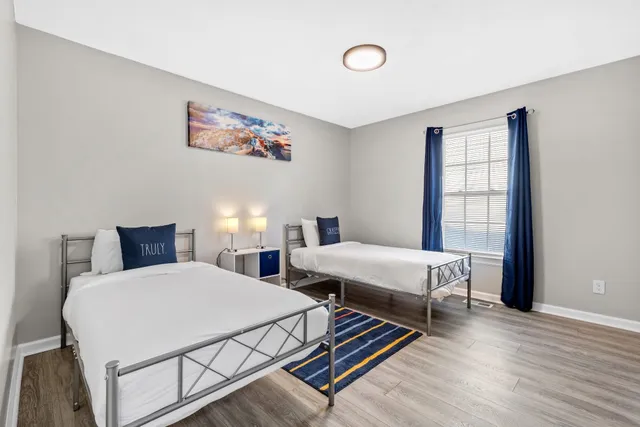 a bedroom with two beds and a window