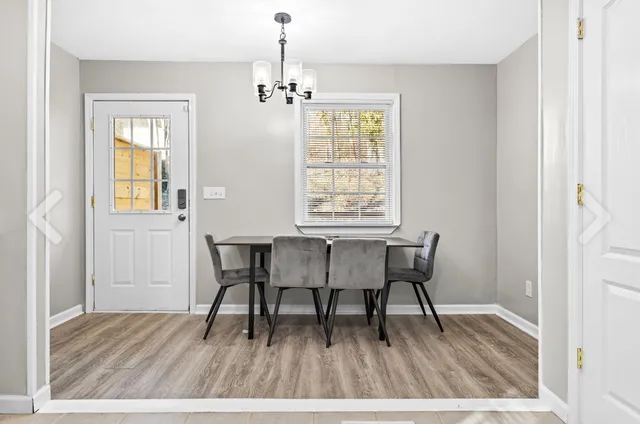 a view of a dining room with furniture and wooden floor