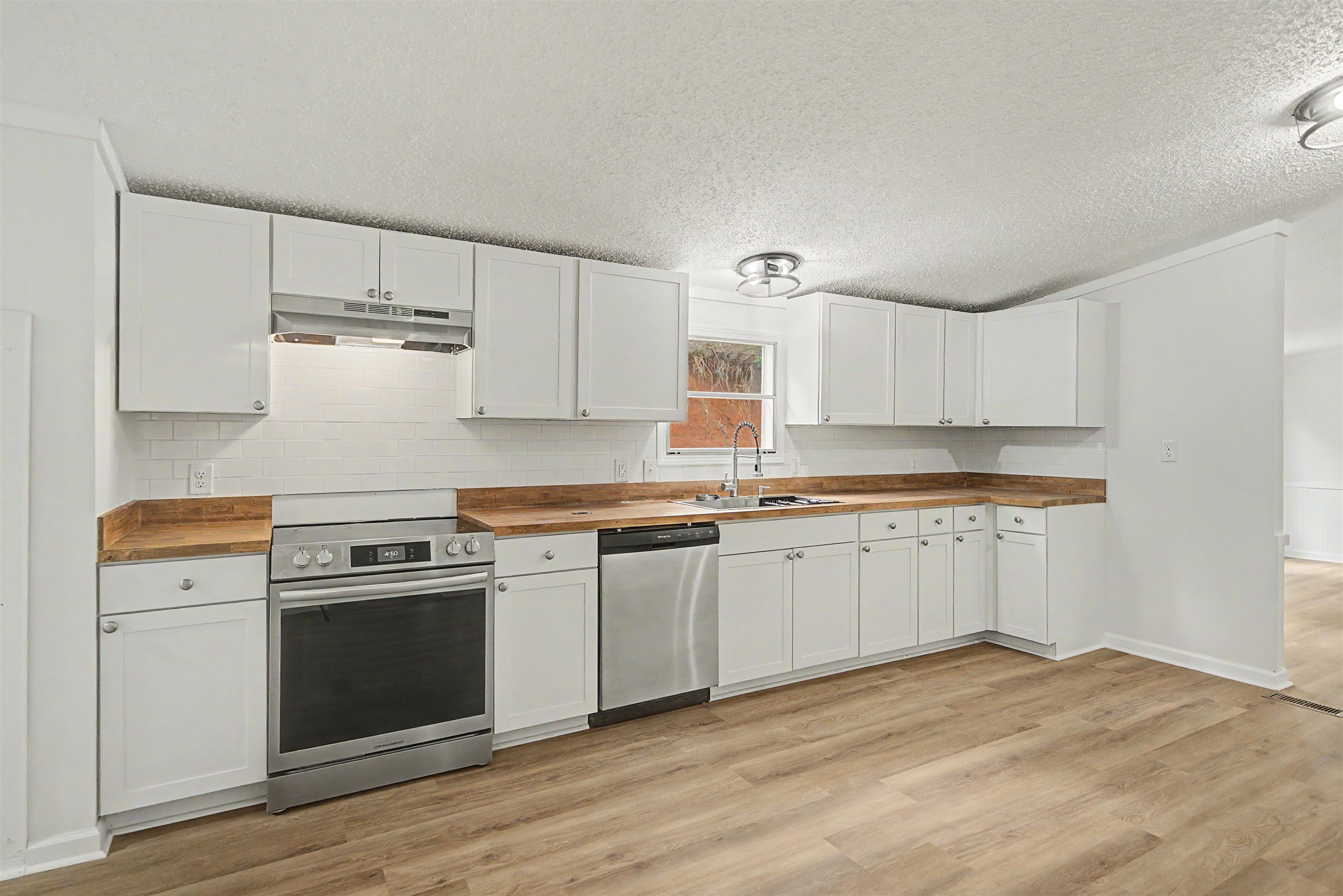 890 Burks Road Savannah, TN 38372 - Photo 10 of 40 a kitchen with granite countertop white cabinets and white appliances