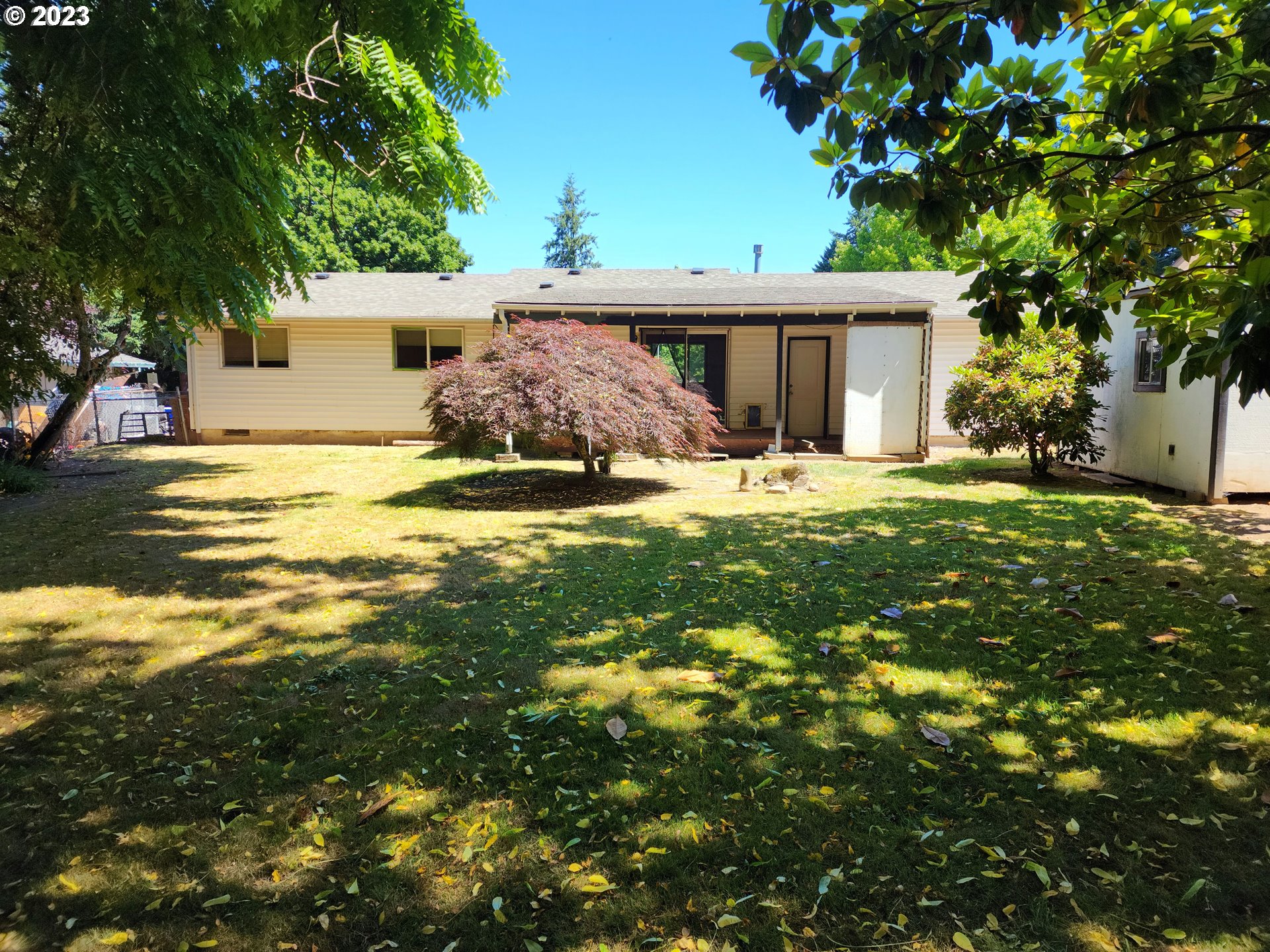 20732 Southeast Main Drive Gresham, OR 97030 - Photo 15 of 27 a front view of a house with a garden and trees