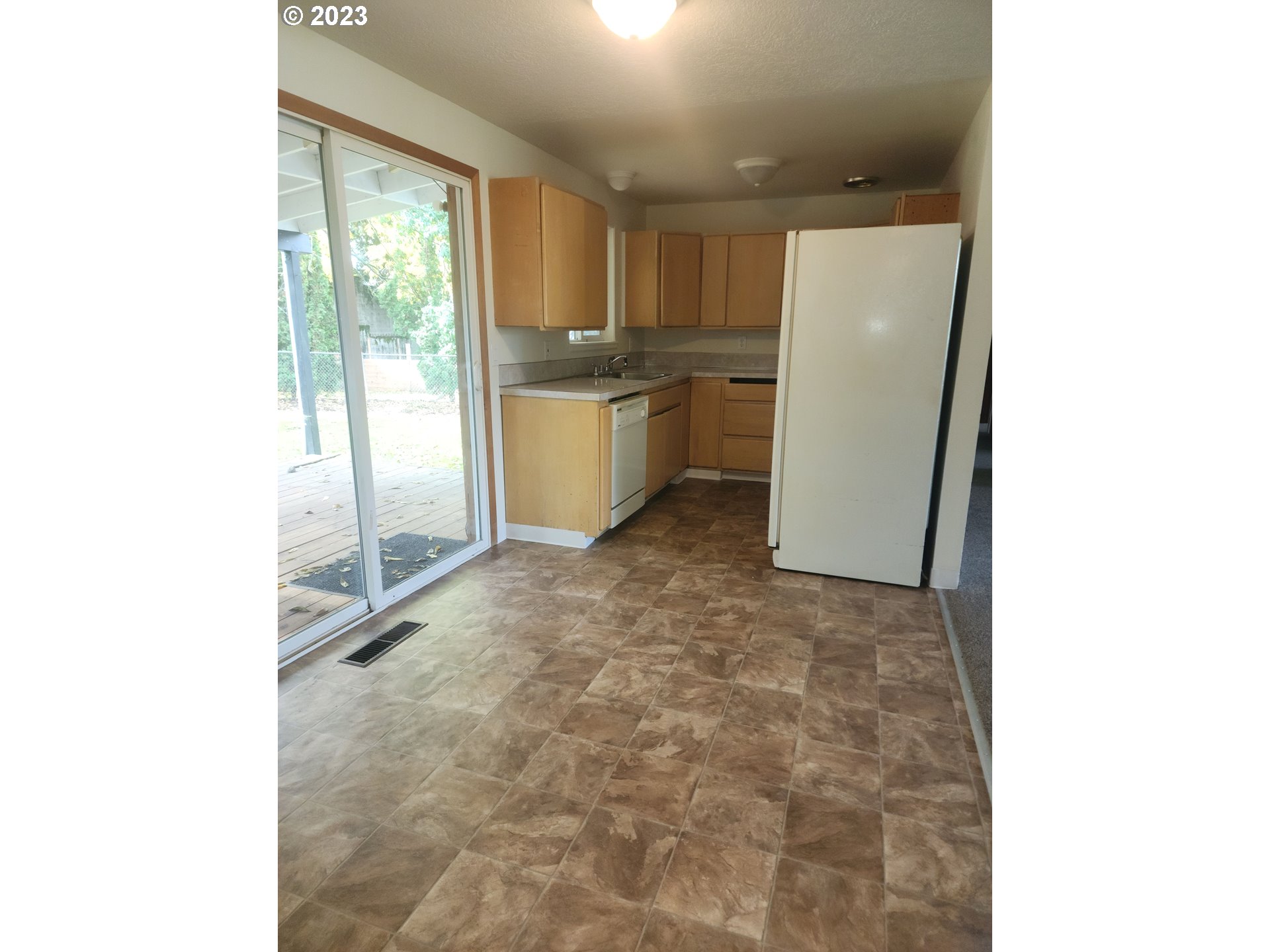 20732 Southeast Main Drive Gresham, OR 97030 - Photo 19 of 27 a view of a kitchen with a sink and refrigerator