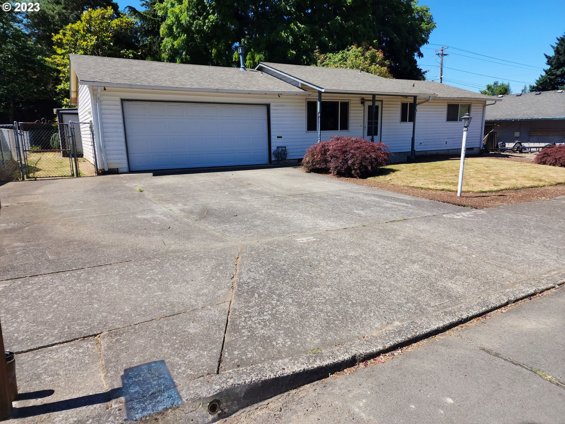 20732 Southeast Main Drive Gresham, OR 97030 - Photo 4 of 27 a front view of a house with a yard and garage