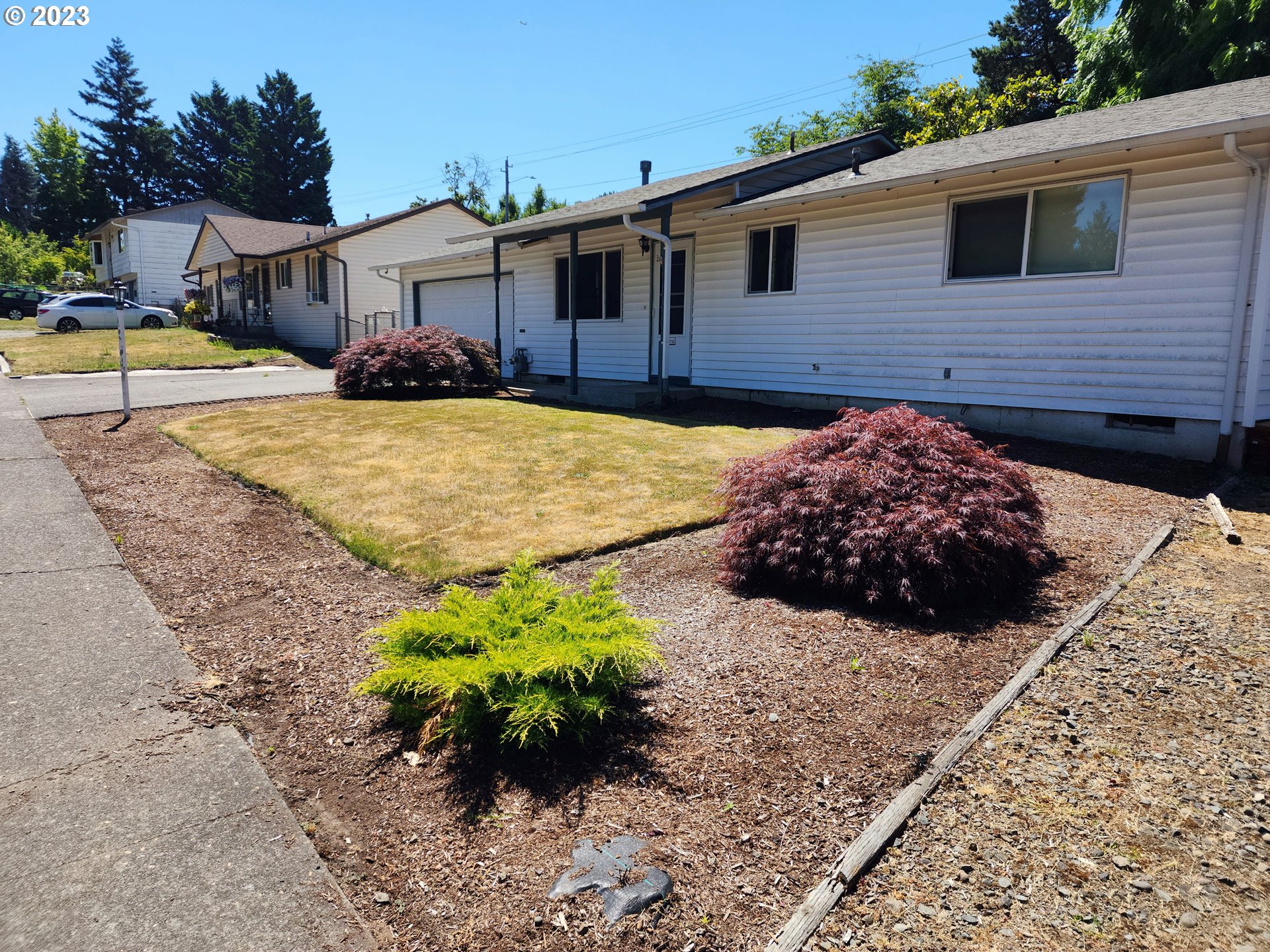 20732 Southeast Main Drive Gresham, OR 97030 - Photo 5 of 27 a front view of a house with a yard and garage