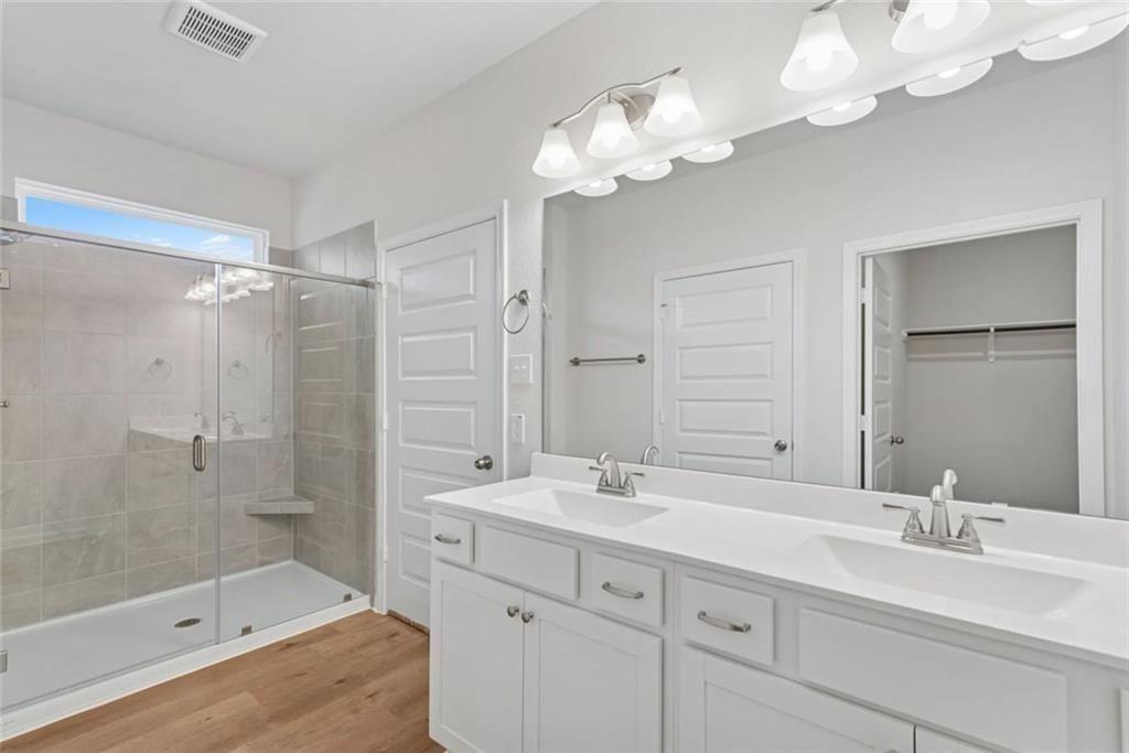 406 Fair Oak Lane Calhoun, GA 30701 - Photo 11 of 13 a bathroom with a double vanity sink mirror and shower