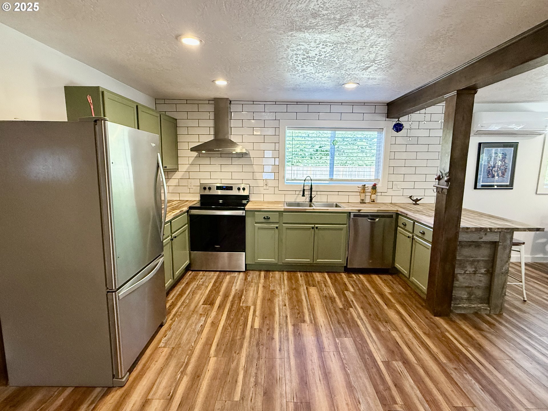 35349 Blitz Lane Blodgett, OR 97326 - Photo 12 of 47 a kitchen with stainless steel appliances granite countertop a refrigerator a sink dishwasher a stove and white countertops with wooden floor