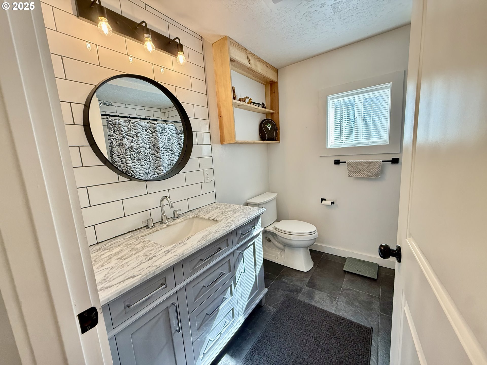35349 Blitz Lane Blodgett, OR 97326 - Photo 7 of 47 a bathroom with a granite countertop toilet a sink and a mirror