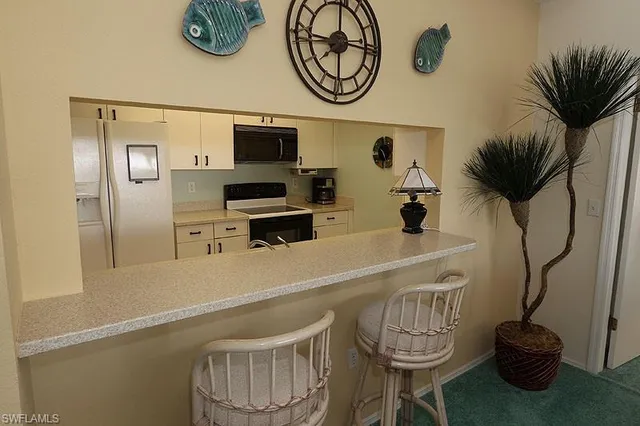a kitchen with stainless steel appliances a sink a stove and a wooden floor