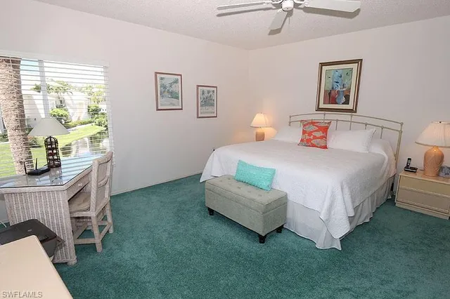 a bedroom with a bed a table and chair