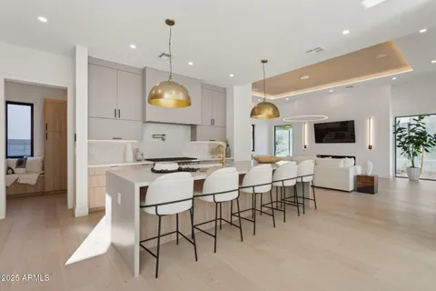 a dining room with furniture a large window and stainless steel appliances