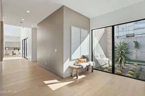 a living room with furniture a flat screen tv and a large window