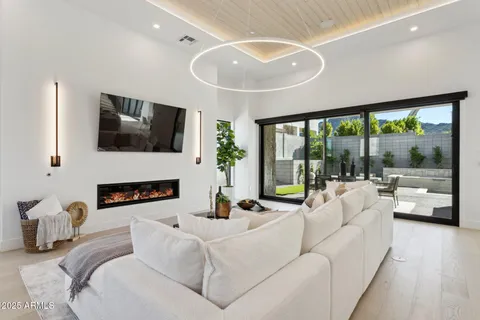a living room with furniture and a chandelier
