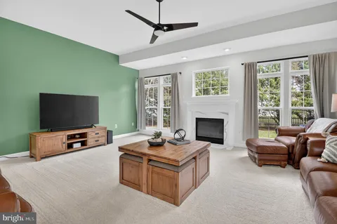 a living room with furniture a fireplace and a window