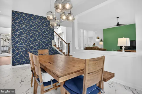 a kitchen with a table chairs and microwave