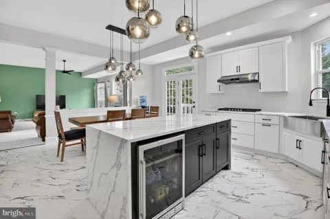 a kitchen with a sink window and cabinets