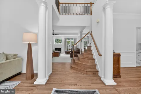 a view of entryway and hall with wooden floor