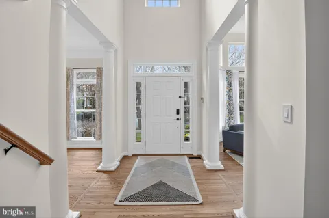 a living room with furniture and a book shelf