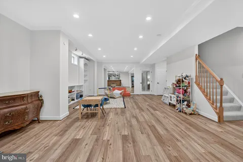 a hallway with wooden floor and furniture