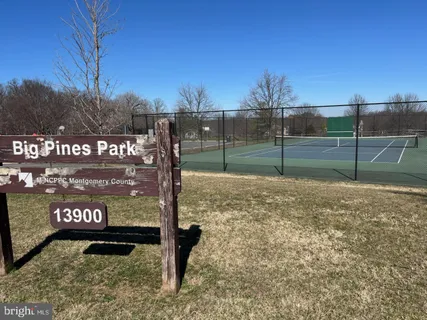 a view of a park with iron fence