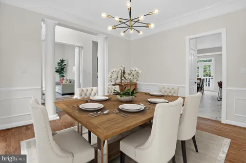 a living room with furniture a large window and a chandelier