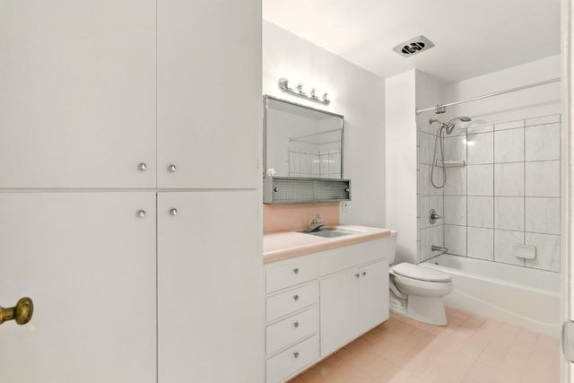 a bathroom with a double vanity sink toilet and shower