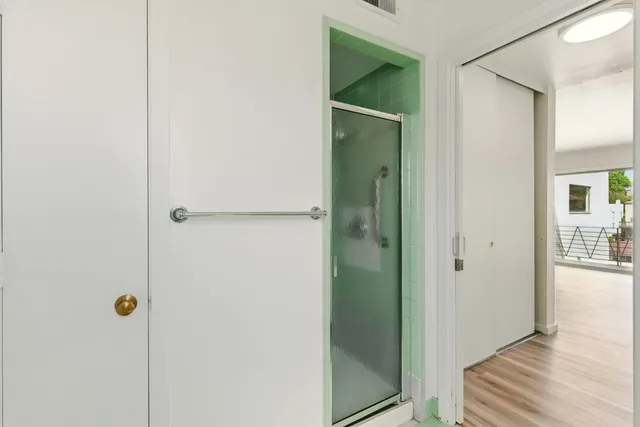 a bathroom with a shower and a mirror
