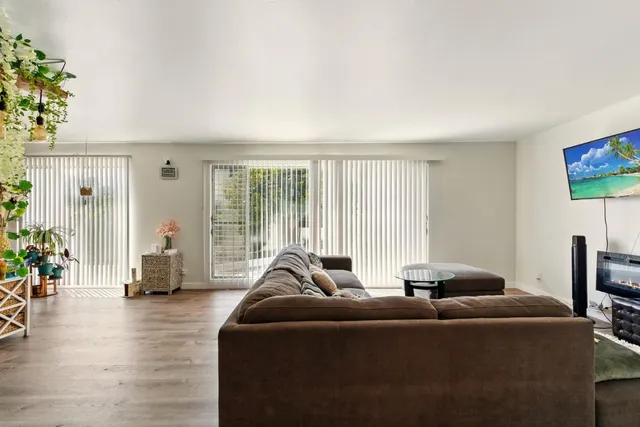 a living room with furniture and floor to ceiling window