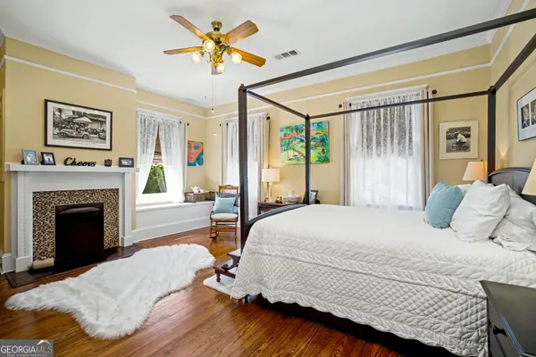 a spacious bedroom with a bed and a chandelier