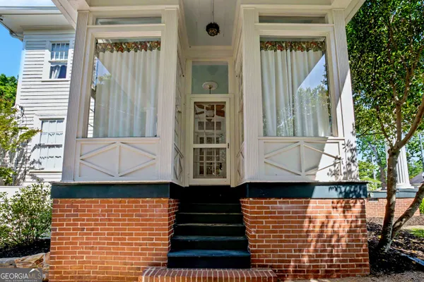 an aerial view of a house with garden space and sitting area