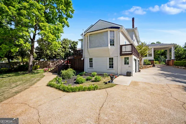 an aerial view of house with a tennis court