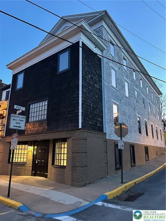 a view of a brick house with many windows