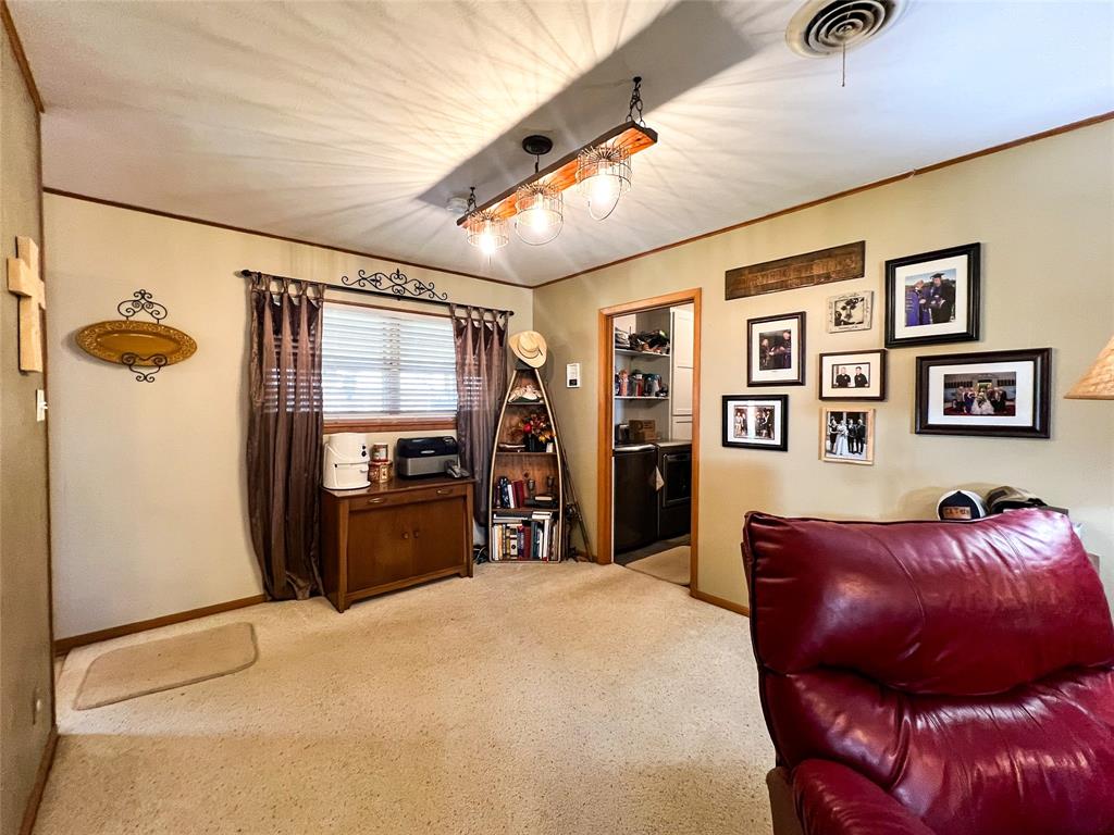 1009 North 7th Street Haskell, TX 79521 - Photo 7 of 26 a bed room with a bed and dresser