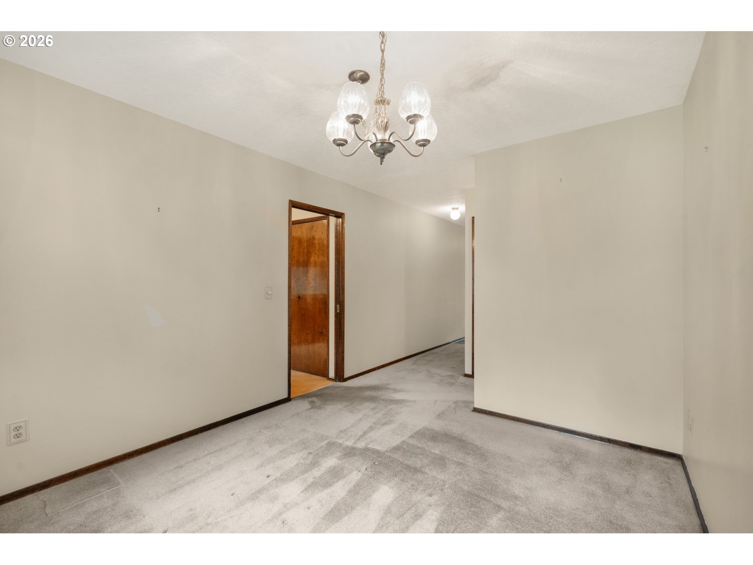 14155 Southwest 27th Street Beaverton, OR 97008 - Photo 9 of 27 a view of an empty room with a chandelier fan