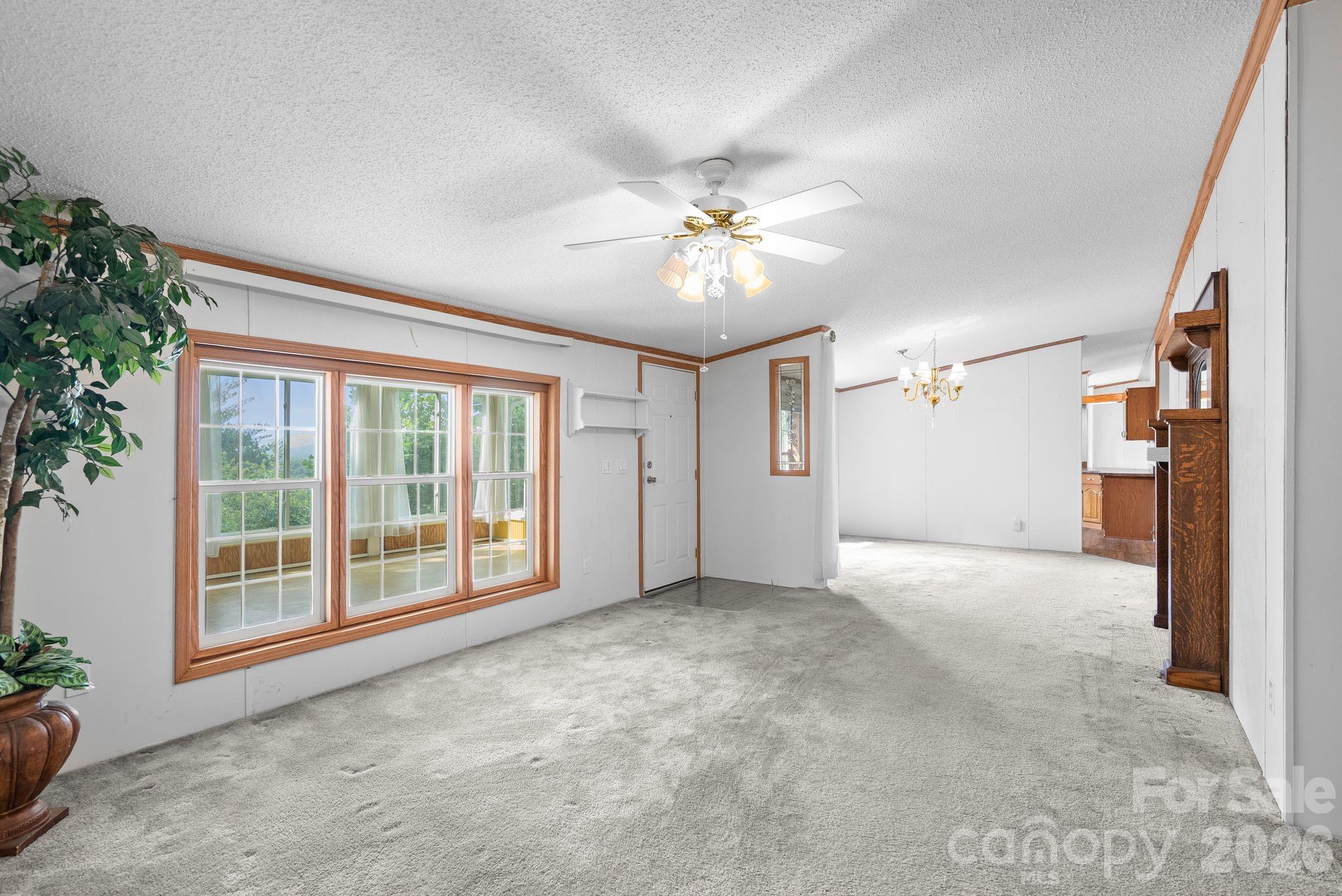 133 Spivey Mountain Road Asheville, NC 28806 - Photo 15 of 40 an empty room with windows and ceiling fan