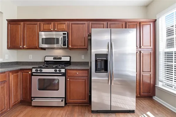 a kitchen with a refrigerator stove and microwave