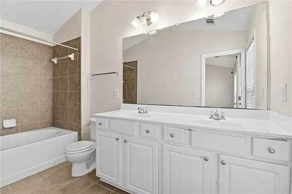 a bathroom with a toilet a sink a bathtub and a mirror