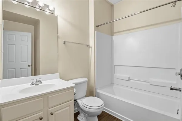 a bathroom with a sink toilet vanity and shower