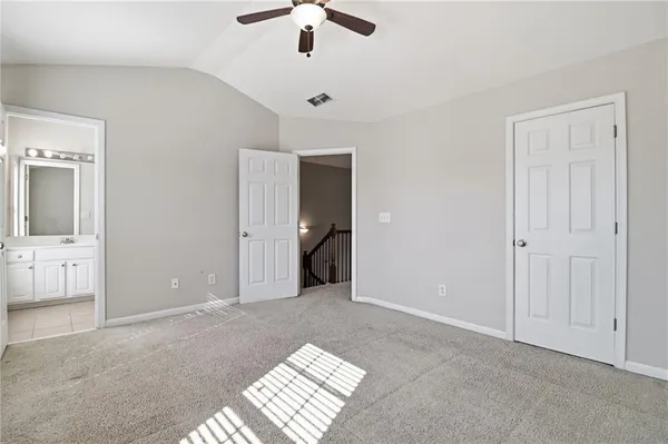 an empty room with fan and entrance