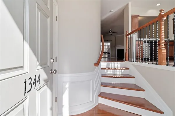 a view of staircase with white walls and railing
