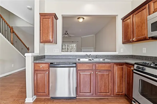 a kitchen with stainless steel appliances granite countertop a stove and a microwave