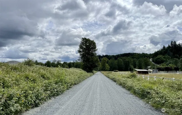 a view of a street with a yard