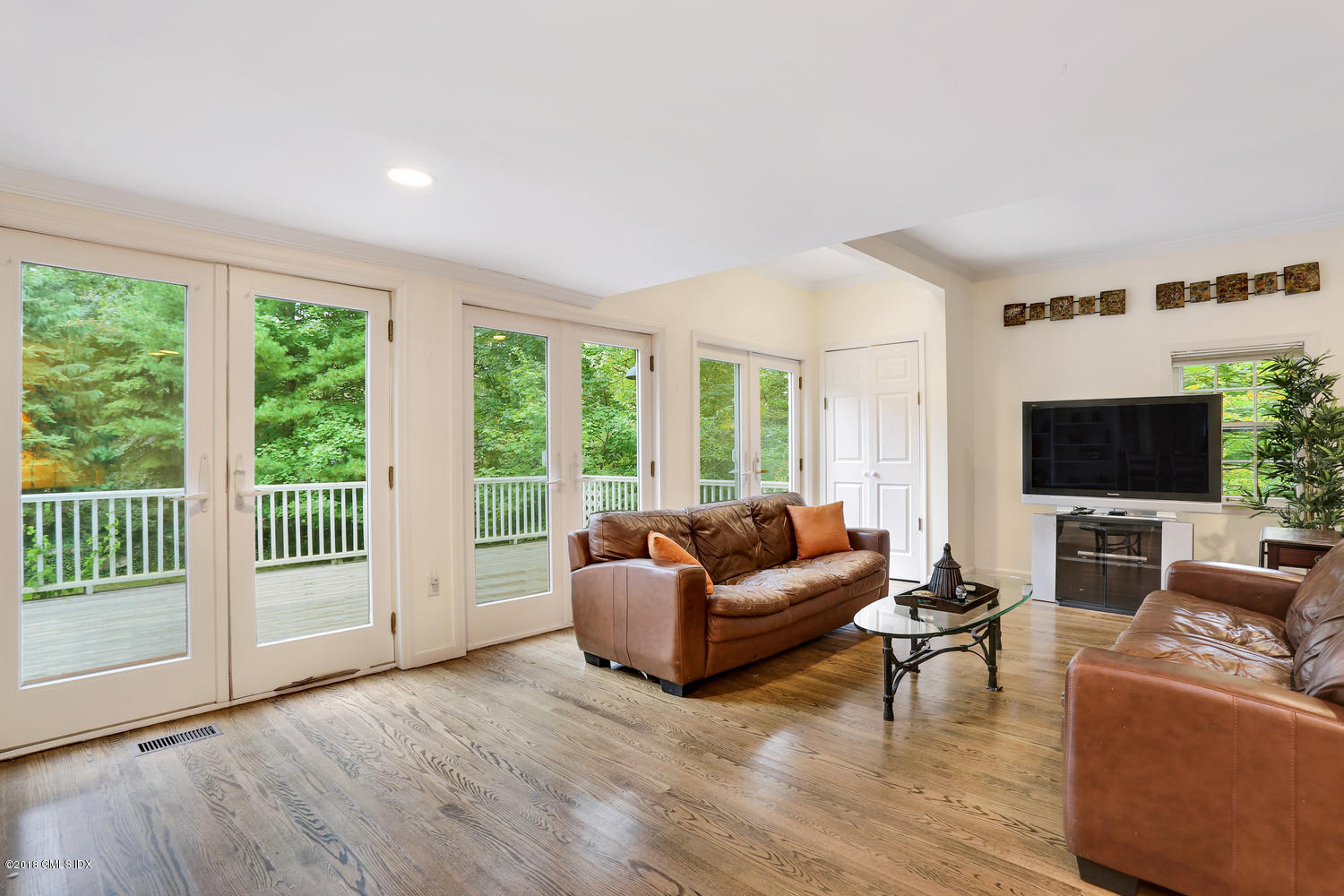 125 Hendrie Avenue Riverside, CT 06878 - Photo 11 of 24 a living room with furniture a flat screen tv and a large window