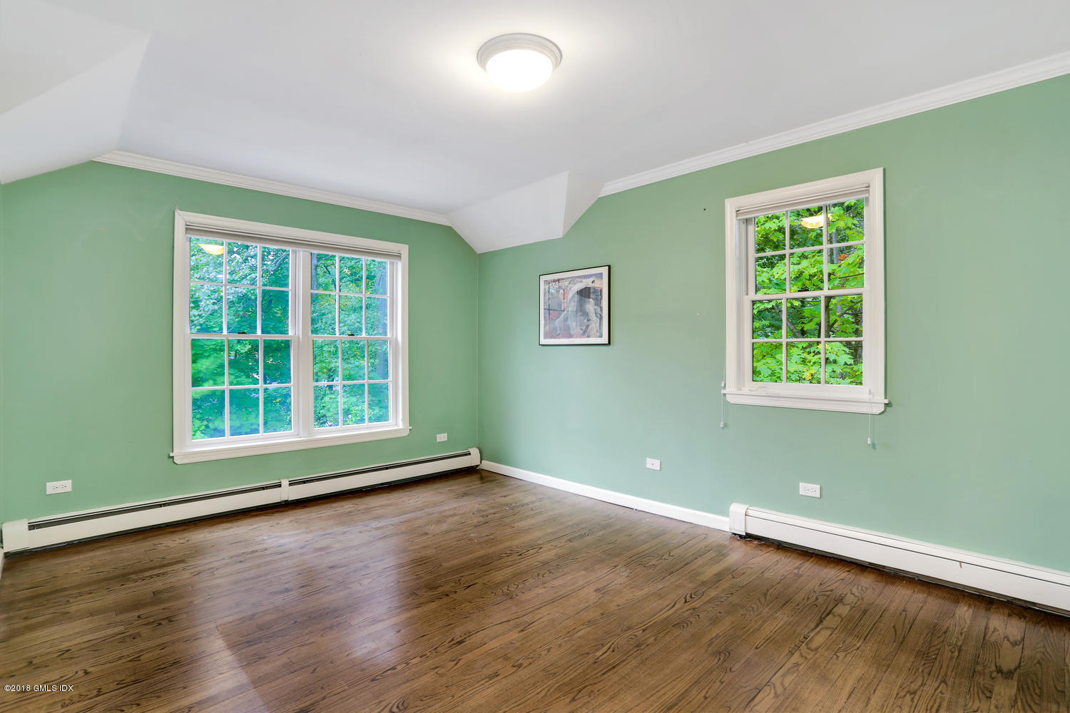 125 Hendrie Avenue Riverside, CT 06878 - Photo 16 of 24 an empty room with wooden floor and windows