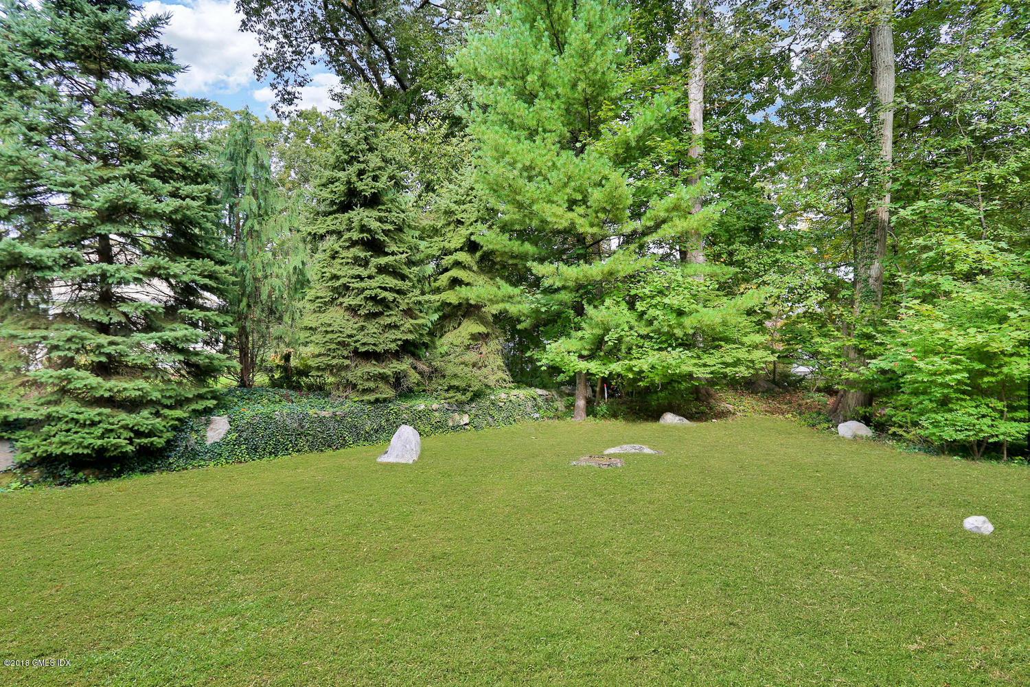 125 Hendrie Avenue Riverside, CT 06878 - Photo 19 of 24 a backyard of a house with a yard and outdoor seating