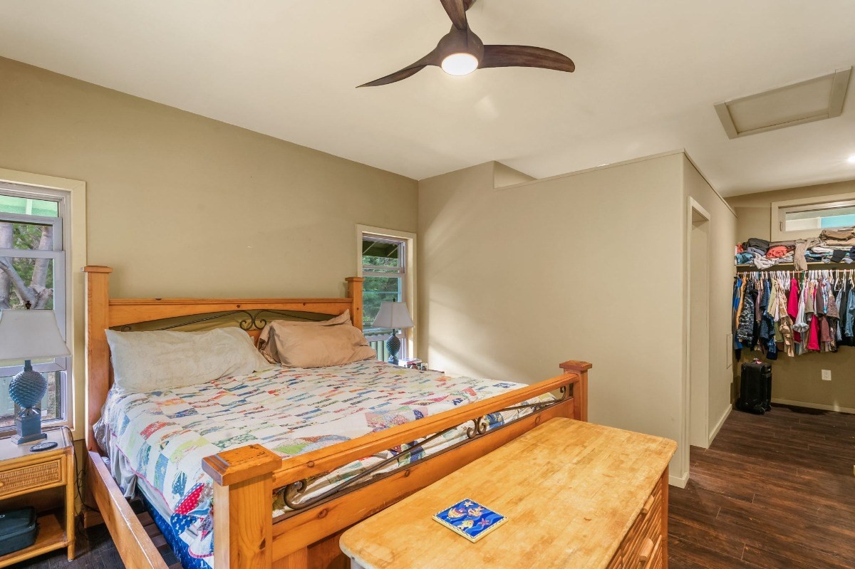 5011 Awawa Road Kalaheo, HI 96741 - Photo 11 of 30 a bedroom with a bed and wooden floor
