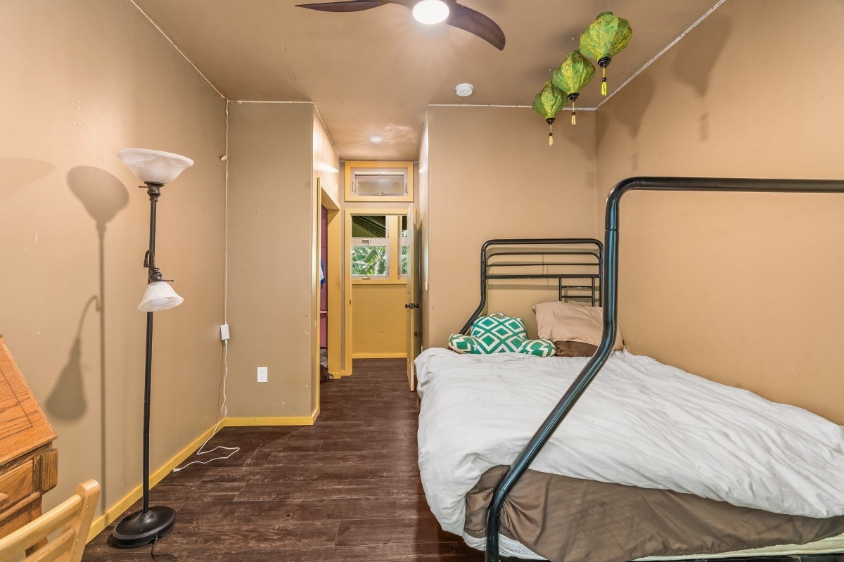 5011 Awawa Road Kalaheo, HI 96741 - Photo 17 of 30 a bedroom with a bed and chandelier