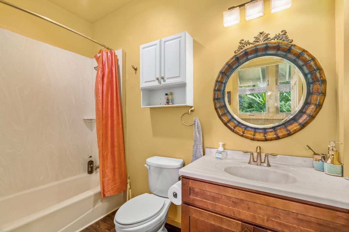 5011 Awawa Road Kalaheo, HI 96741 - Photo 18 of 30 a bathroom with a sink a toilet and a mirror
