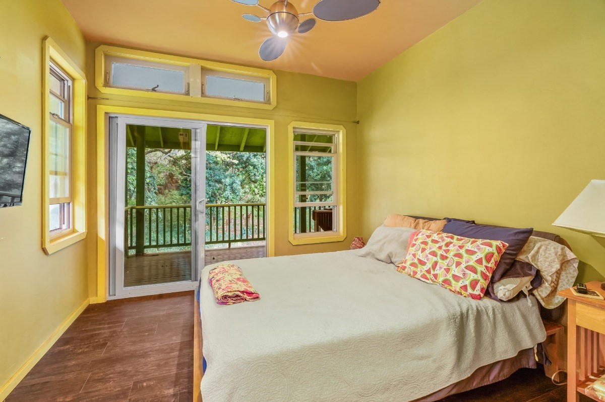 5011 Awawa Road Kalaheo, HI 96741 - Photo 19 of 30 a bedroom with a bed and a large window