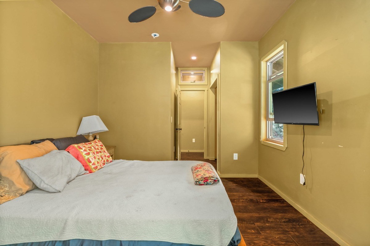 5011 Awawa Road Kalaheo, HI 96741 - Photo 20 of 30 a bedroom with a large bed and a chandelier
