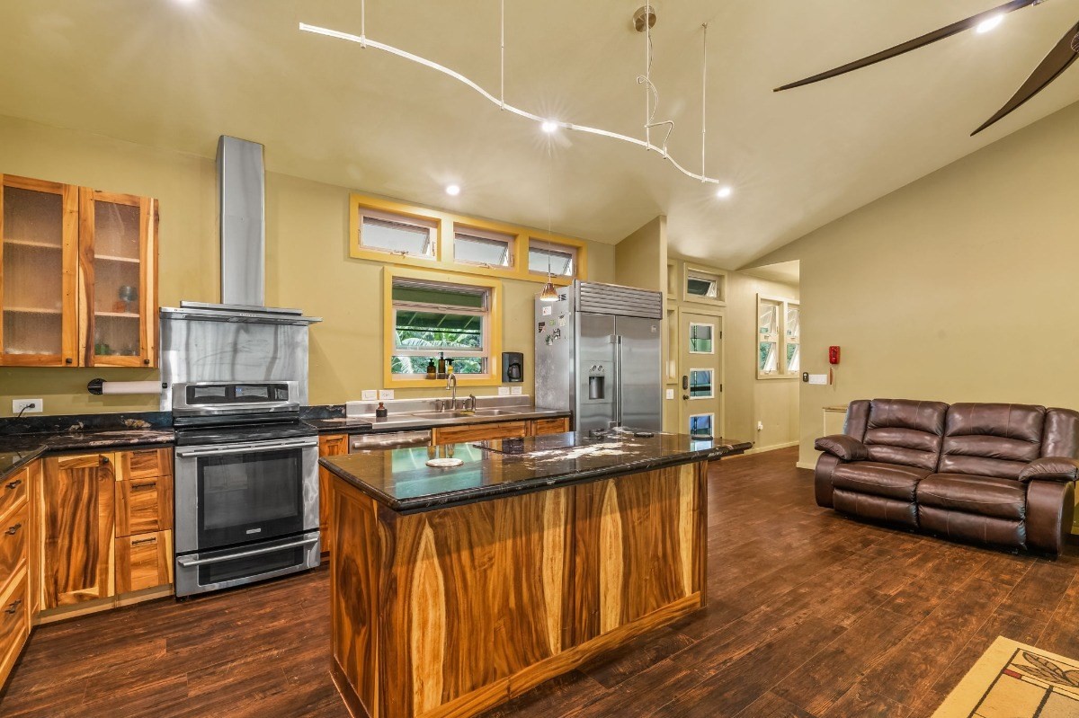 5011 Awawa Road Kalaheo, HI 96741 - Photo 2 of 30 a kitchen with stainless steel appliances granite countertop a stove and a sink