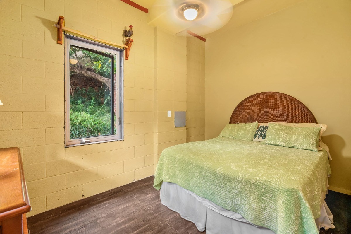 5011 Awawa Road Kalaheo, HI 96741 - Photo 26 of 30 a bedroom with a bed and a window